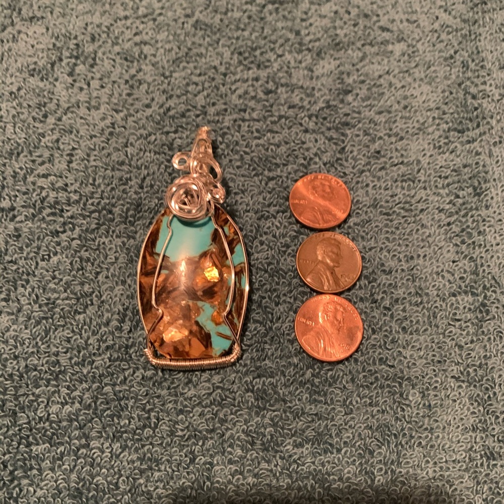 Handmade silver plated wire wrapped stone.